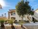 Multi-story apartment building featuring lush landscaping at 6701 Squaw Mountain Dr # 201, Las Vegas, NV 89130