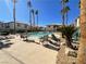 Community pool area surrounded by palm trees and lounge chairs at 6701 Squaw Mountain Dr # 201, Las Vegas, NV 89130