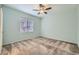 Cozy bedroom with neutral paint, ceiling fan, and a bright window overlooking the outside at 6868 Sky Pointe Dr # 1087, Las Vegas, NV 89131