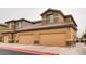 A view of the exterior of the property with large garages and well-kept landscaping at 6868 Sky Pointe Dr # 1087, Las Vegas, NV 89131