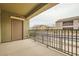 Relaxing covered patio with black railings overlooking the neighborhood and greenery at 6868 Sky Pointe Dr # 1087, Las Vegas, NV 89131