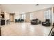 Open concept living room and dining area with tile floors, lots of natural light, and neutral paint at 7063 Salt Plains St, North Las Vegas, NV 89086