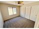 This bedroom includes carpet, a window, and a closet for efficient storage at 7896 Muldrow St, Las Vegas, NV 89139