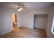 Bedroom featuring modern ceiling fan, wood-look flooring, and spacious closet at 7932 Diamond Rock Way # 101, Las Vegas, NV 89128