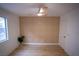 Bright bedroom with a modern ceiling fan, wood floors, and decorative grid accent wall at 7932 Diamond Rock Way # 101, Las Vegas, NV 89128