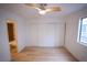 Bedroom featuring wood-look floors, ample closet space, and updated features at 7932 Diamond Rock Way # 101, Las Vegas, NV 89128