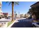 Picturesque street view featuring an ornate roundabout, palm trees, classic lampposts, and upscale building facades at 7932 Diamond Rock Way # 101, Las Vegas, NV 89128