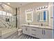 Bathroom featuring marble style shower and tile floors, modern lighting, and dual vanity sinks at 8625 Scarsdale Dr, Las Vegas, NV 89117