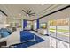 Modern primary bedroom with tray ceiling, pool view, and vanity area at 8625 Scarsdale Dr, Las Vegas, NV 89117