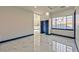 A bright bedroom with a marble floor, blue baseboards, a closet, and a view of the outside at 8625 Scarsdale Dr, Las Vegas, NV 89117