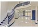 Large foyer with spiral stairs, marble floors, and fireplace view at 8625 Scarsdale Dr, Las Vegas, NV 89117