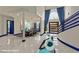 Grand foyer with high ceilings, a spiral staircase, and contemporary blue accents at 8625 Scarsdale Dr, Las Vegas, NV 89117