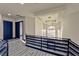 Upstairs hallway with stylish railings, wood-look floors, and modern lighting fixture at 8625 Scarsdale Dr, Las Vegas, NV 89117