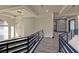 Upstairs hallway with stylish railings, wood-look floors, and modern lighting fixture at 8625 Scarsdale Dr, Las Vegas, NV 89117