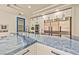 Close up on a modern kitchen island with marble countertops and stainless steel appliances at 8625 Scarsdale Dr, Las Vegas, NV 89117