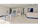 Spacious kitchen with marble floors, two islands, a bar, stainless appliances, and white cabinetry at 8625 Scarsdale Dr, Las Vegas, NV 89117