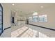 Bright living room offering a view of the adjacent kitchen, showcasing the open floor plan and modern finishes at 8625 Scarsdale Dr, Las Vegas, NV 89117