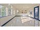 Bright and airy living room with large windows and marble floors, perfect for entertaining and relaxation at 8625 Scarsdale Dr, Las Vegas, NV 89117