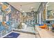 Spacious main bath features luxury tile, glass shower, soaking tub, dual vanities, and custom mirror at 8625 Scarsdale Dr, Las Vegas, NV 89117