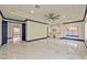 Bright main bedroom features tray ceilings, fan, marble floors, and vanity with a large framed mirror at 8625 Scarsdale Dr, Las Vegas, NV 89117