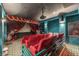 Home theater with red seating, a projector, and theatrical curtains for a cinematic experience at 8625 Scarsdale Dr, Las Vegas, NV 89117