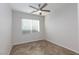 Bright bedroom with a ceiling fan, large window, and beautiful parquet flooring at 9085 Bridal Creek Ave, Las Vegas, NV 89178