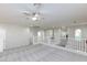 Neutral loft area featuring white railings, neutral carpet, bright light, and white doors at 9085 Bridal Creek Ave, Las Vegas, NV 89178