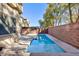 Backyard with a narrow pool, privacy wall, and desert landscaping at 9085 Bridal Creek Ave, Las Vegas, NV 89178