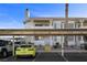 Exterior view of the condo building showing assigned parking and well-kept landscaping at 917 Boulder Springs Dr # 202, Las Vegas, NV 89128