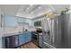 Well-equipped kitchen featuring stainless steel appliances and blue cabinetry at 917 Boulder Springs Dr # 202, Las Vegas, NV 89128