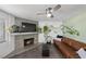 Comfortable living room with a fireplace, large window, and a brown leather sofa at 917 Boulder Springs Dr # 202, Las Vegas, NV 89128