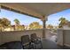 Private outdoor patio with seating, offering views of the surrounding community, and mature trees at 917 Boulder Springs Dr # 202, Las Vegas, NV 89128