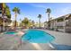 Community pool featuring a lap pool, jacuzzi, lounge chairs, and palm trees at 917 Boulder Springs Dr # 202, Las Vegas, NV 89128