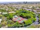An aerial view showing the community tennis courts among trees, residential homes, and manicured green spaces at 9325 Canyon Classic Dr, Las Vegas, NV 89144