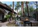Tranquil backyard featuring a luxurious pool, spa, and lush tropical landscaping at 9325 Canyon Classic Dr, Las Vegas, NV 89144