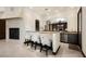 Bar area featuring granite countertops, stainless steel appliances, and bar seating at 9325 Canyon Classic Dr, Las Vegas, NV 89144