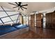 Spacious bedroom with unique wall design, ceiling fan, and barn door access at 9325 Canyon Classic Dr, Las Vegas, NV 89144