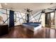 Large bedroom featuring distinctive accent wall, ceiling fan and balcony access at 9325 Canyon Classic Dr, Las Vegas, NV 89144