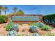 Inviting stone signage for Canyon Fairways is surrounded by desert plants and flowers creating a tranquil setting at 9325 Canyon Classic Dr, Las Vegas, NV 89144