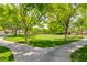 Lush community park with green grass, mature trees, walking path, and shaded picnic areas at 9325 Canyon Classic Dr, Las Vegas, NV 89144