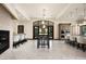 Dining area with a fireplace, bar seating, views to the outdoor space and kitchen at 9325 Canyon Classic Dr, Las Vegas, NV 89144