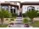 A grand entrance with stone walkway, manicured plants, and an iron gate at 9325 Canyon Classic Dr, Las Vegas, NV 89144