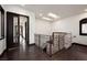 Bright hallway with wood floors and ornate railing leads to other areas of the home at 9325 Canyon Classic Dr, Las Vegas, NV 89144