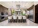 A gourmet kitchen featuring stainless steel appliances, a large island, and pendant lighting at 9325 Canyon Classic Dr, Las Vegas, NV 89144