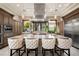 Open kitchen with a center island, stainless-steel appliances and a large vent hood at 9325 Canyon Classic Dr, Las Vegas, NV 89144