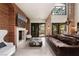 Bright living room featuring a fireplace, exposed stone, and large windows at 9325 Canyon Classic Dr, Las Vegas, NV 89144