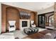 Cozy living room with a stone fireplace, comfortable seating, and access to the courtyard at 9325 Canyon Classic Dr, Las Vegas, NV 89144