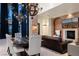 Elegant living room featuring a stone accent wall, modern chandeliers, and courtyard views at 9325 Canyon Classic Dr, Las Vegas, NV 89144