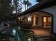 A serene backyard pool and spa illuminated with soft lighting and archway entry, with a covered patio perfect for outdoor relaxation at 9325 Canyon Classic Dr, Las Vegas, NV 89144