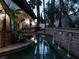 Picturesque water feature with stone accents, flowing waterfalls, and tropical plants at 9325 Canyon Classic Dr, Las Vegas, NV 89144